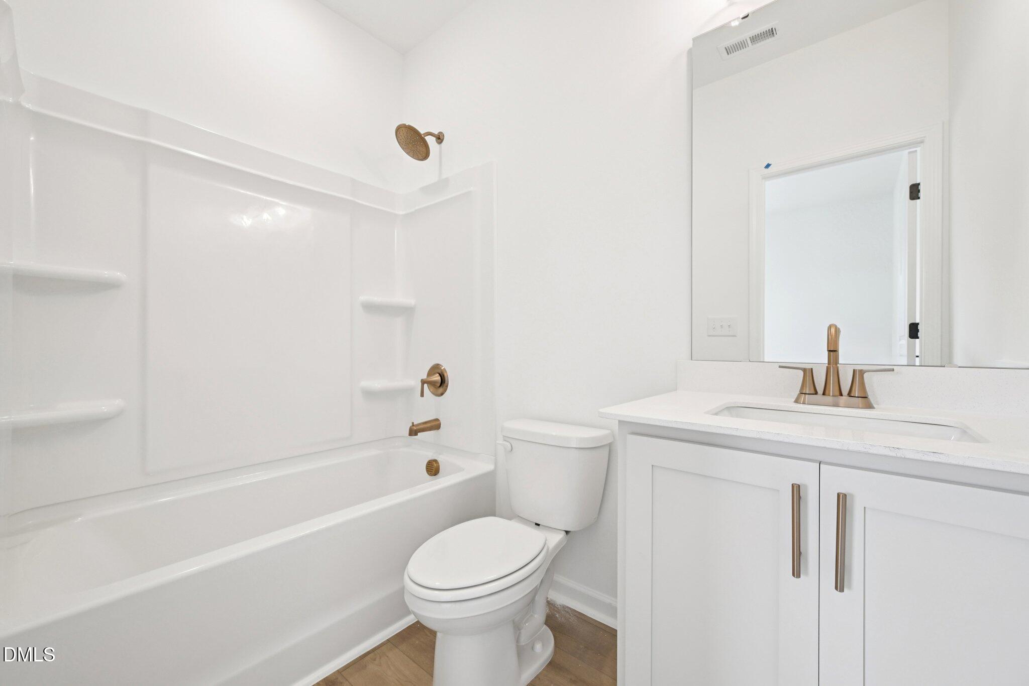 916 Fetching Place, Unit 344 Rolesville, NC 27571 - Photo 26 of 37 a bathroom with a sink a toilet and shower