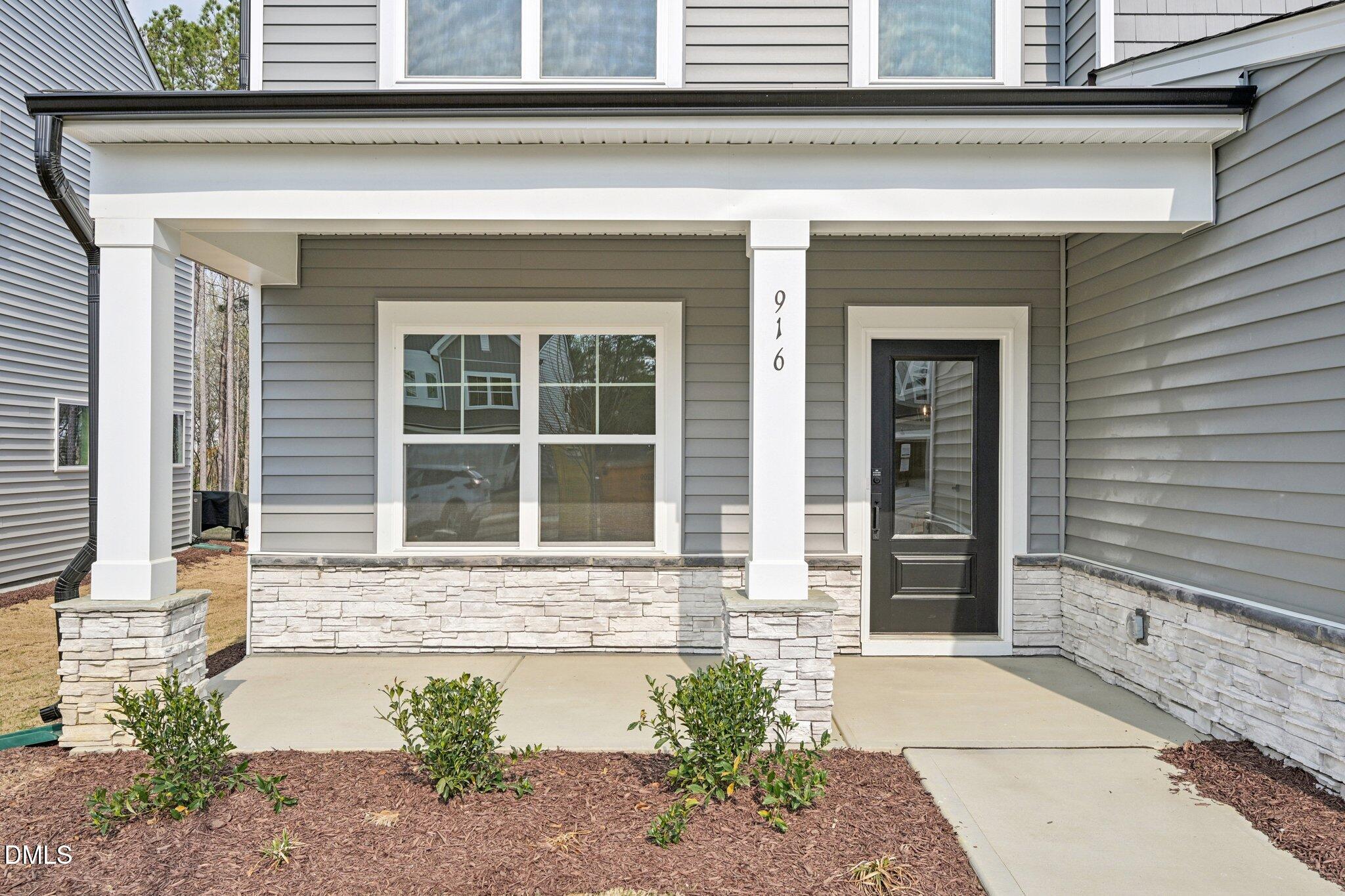 916 Fetching Place, Unit 344 Rolesville, NC 27571 - Photo 3 of 37 a front view of a house with a yard