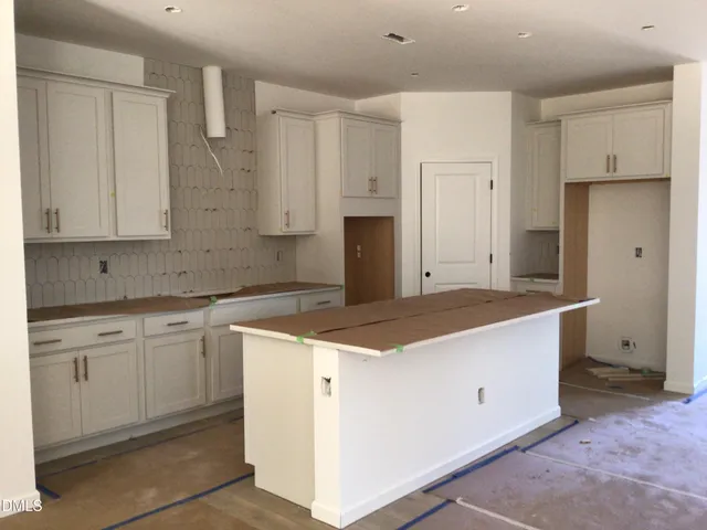 a kitchen with granite countertop cabinets and white appliances