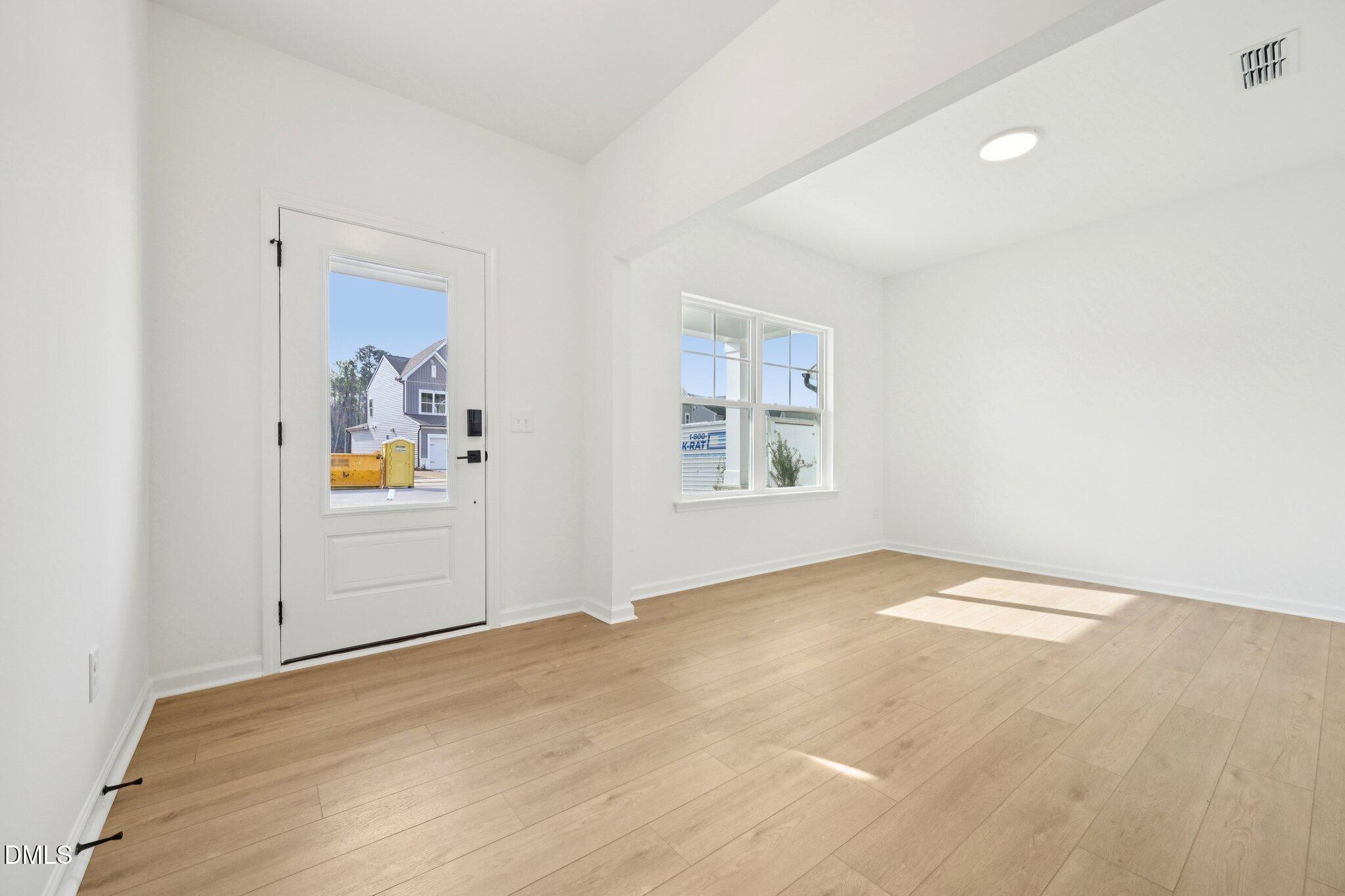 916 Fetching Place, Unit 344 Rolesville, NC 27571 - Photo 4 of 37 an empty room with windows and cabinet