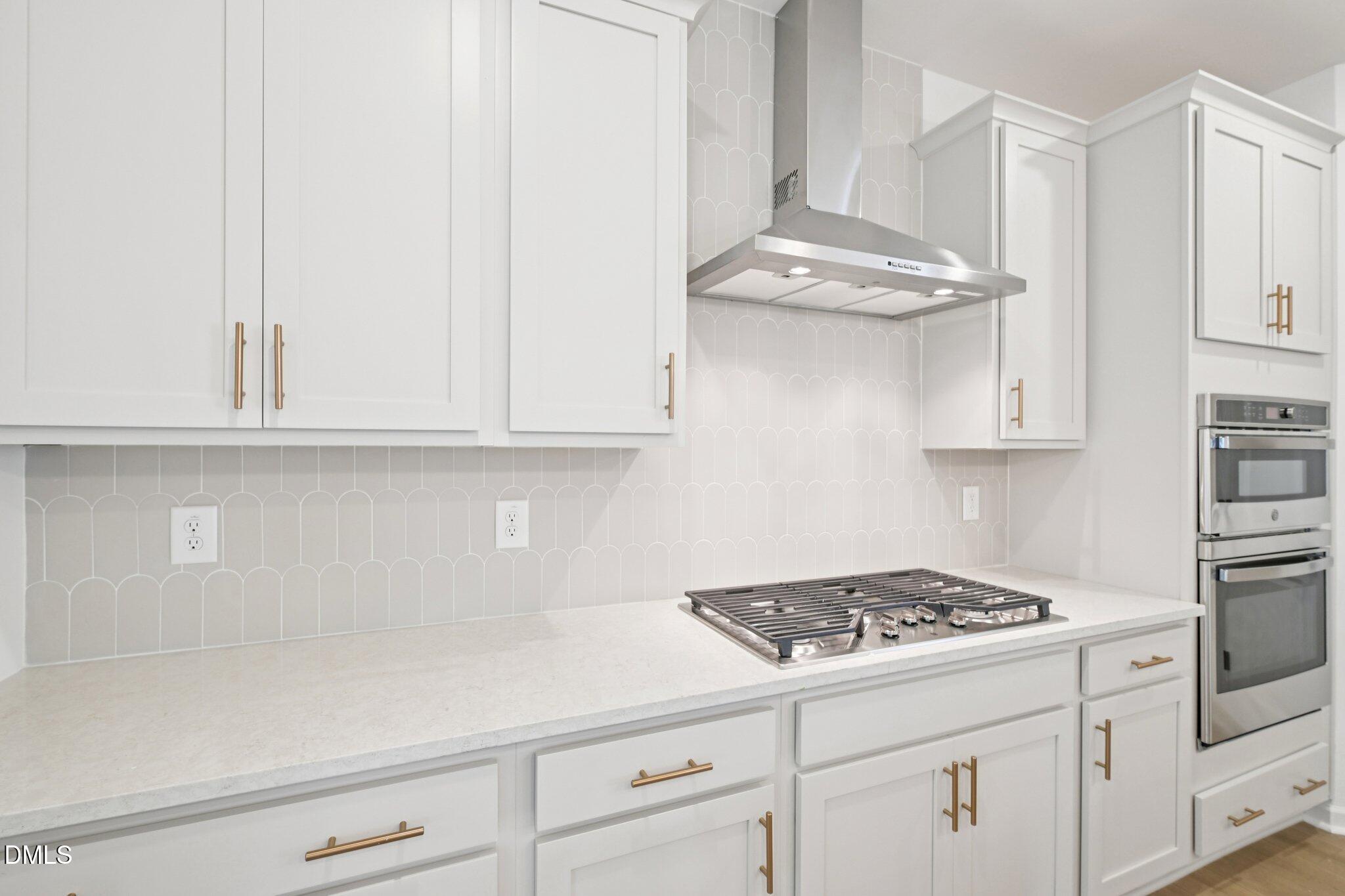 916 Fetching Place, Unit 344 Rolesville, NC 27571 - Photo 8 of 37 a kitchen with white cabinets and appliances