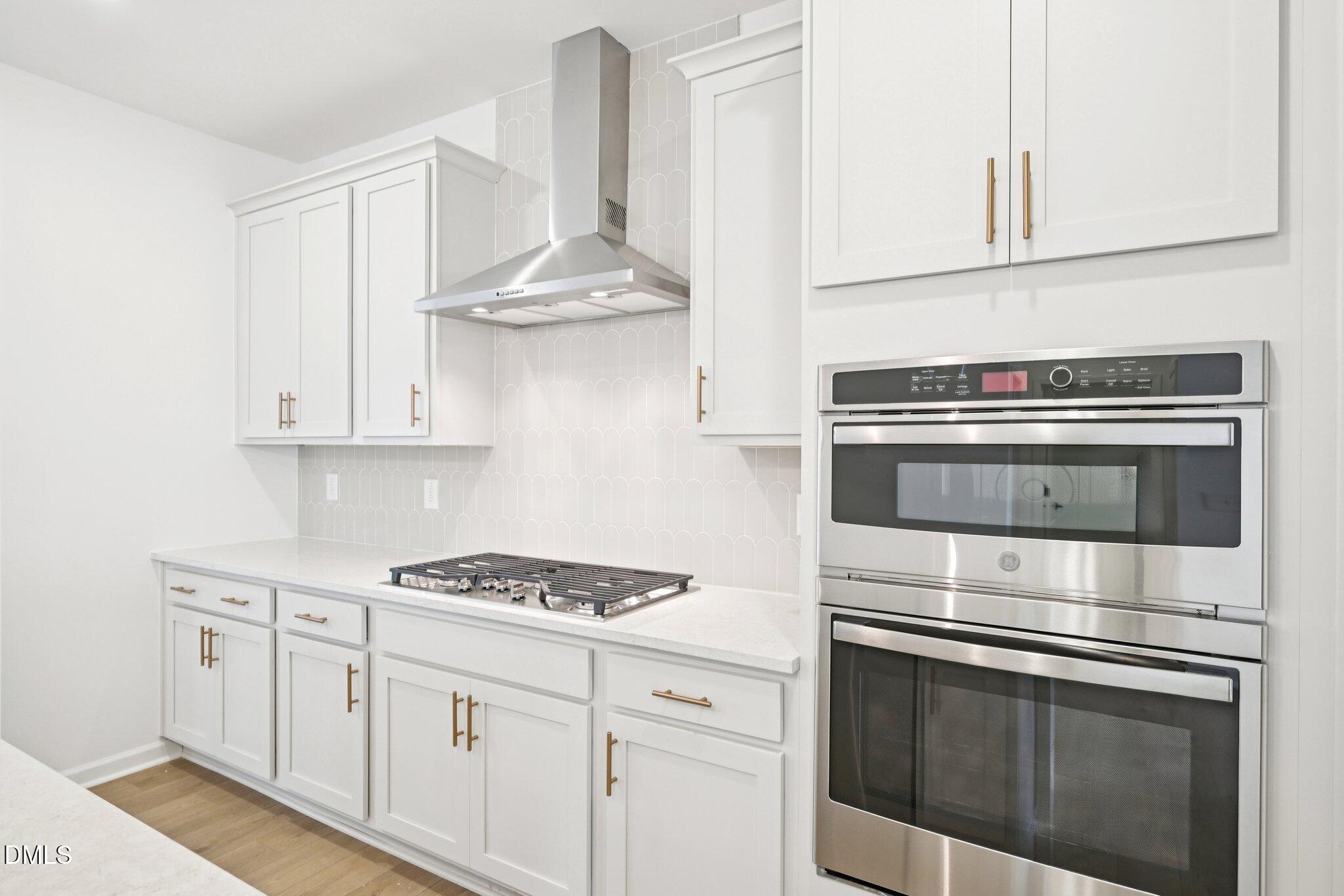 916 Fetching Place, Unit 344 Rolesville, NC 27571 - Photo 9 of 37 a kitchen with white cabinets and appliances
