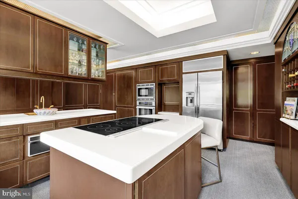 a kitchen that has a sink and stainless steel appliances