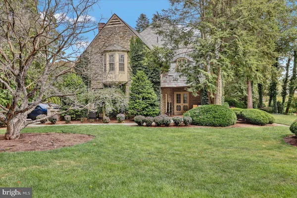 a view of a house with a yard and potted plants