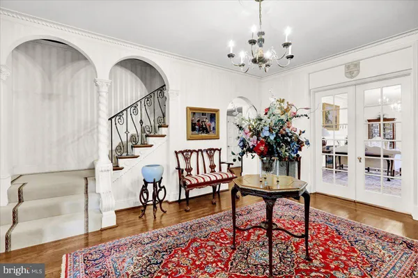 a view of a livingroom with furniture wooden floor and a chandelier