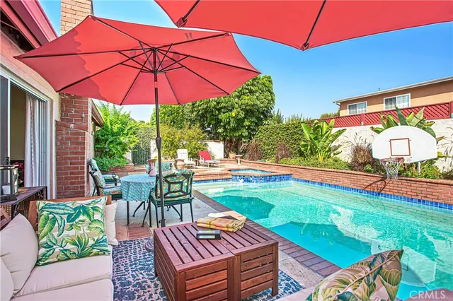 a patio with a table and chairs under an umbrella