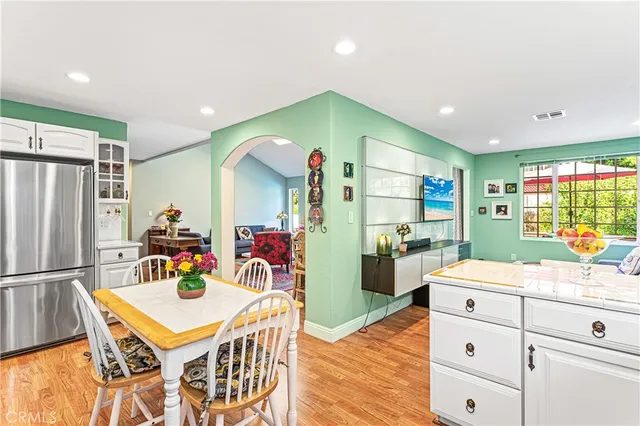 a view of a dining room with furniture a chandelier and wooden floor