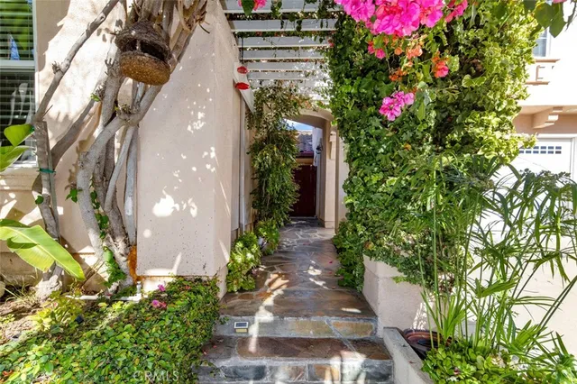 a kitchen with stainless steel appliances kitchen island granite countertop a stove top oven a sink a dining table and chairs with wooden floor