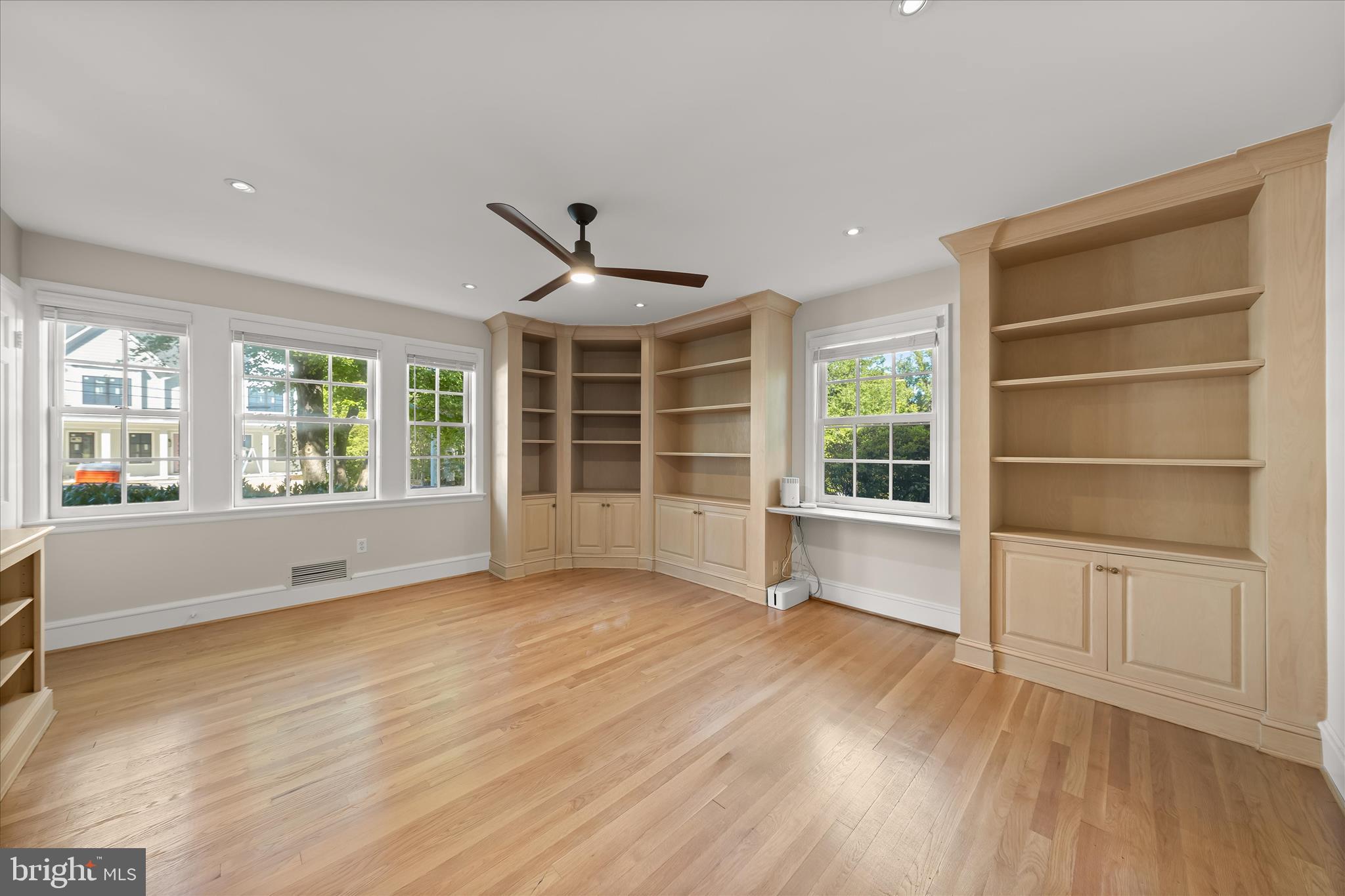 5104 Scarsdale Road Bethesda, MD 20816 - Photo 7 of 68 a view of an empty room with a window and wooden floor