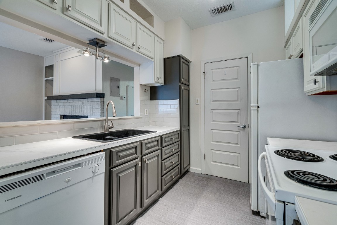 908 Poplar Street, Unit 208 Austin, TX 78705 - Photo 12 of 26 a kitchen with stainless steel appliances granite countertop a sink and a refrigerator
