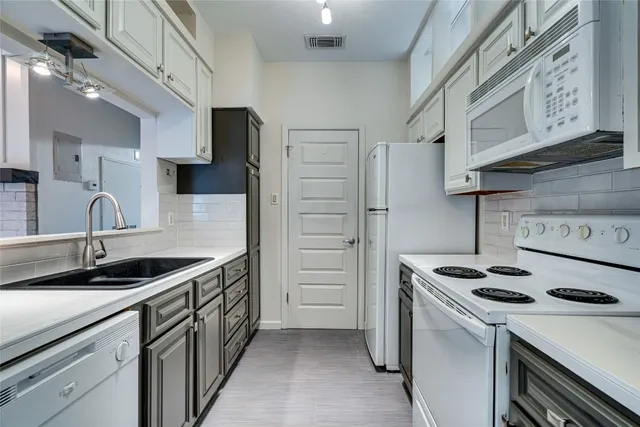 a kitchen that has a sink and a stove