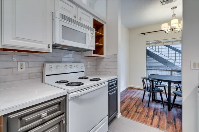 a kitchen with a stove and a microwave