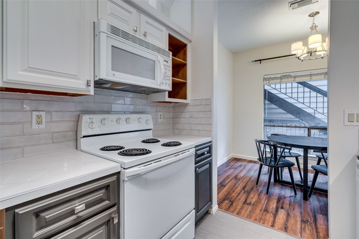 908 Poplar Street, Unit 208 Austin, TX 78705 - Photo 16 of 26 a kitchen with a stove and a microwave