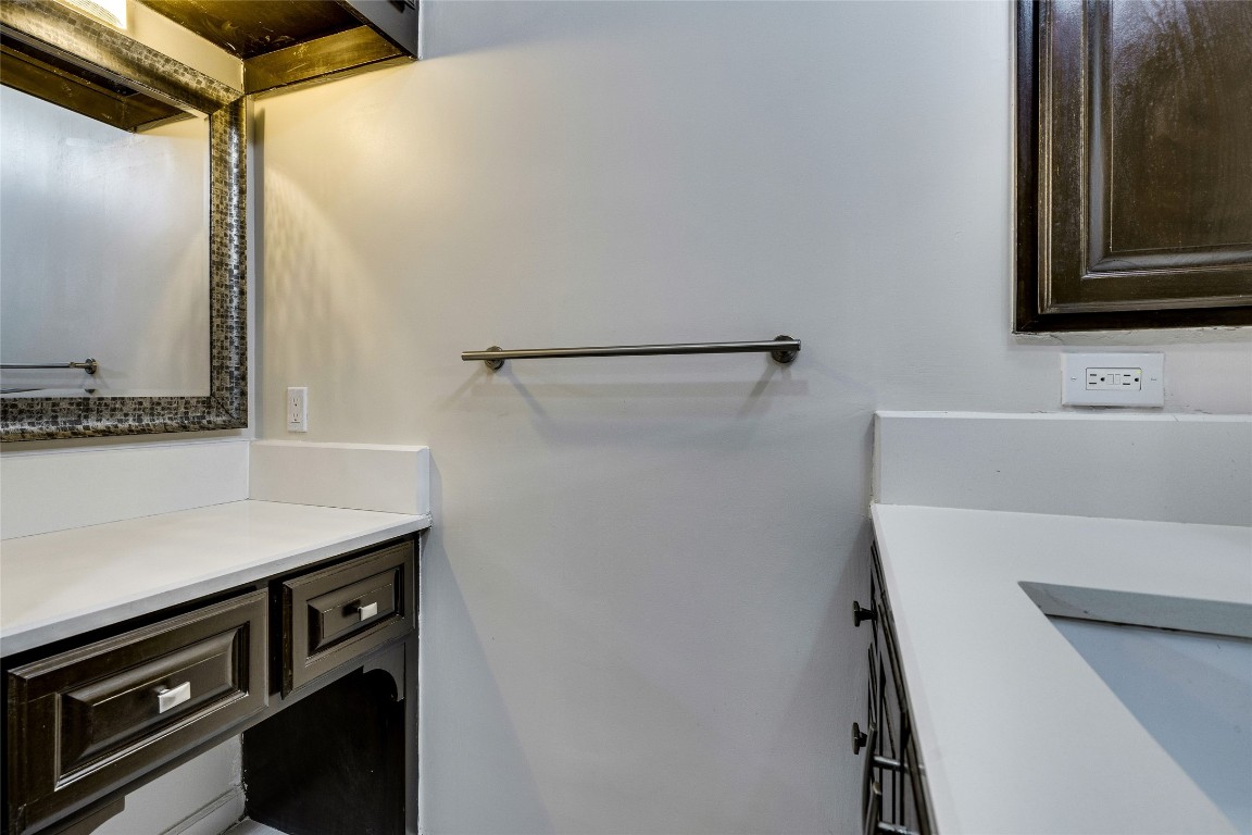 908 Poplar Street, Unit 208 Austin, TX 78705 - Photo 24 of 26 a view of a bathroom with a sink and a mirror