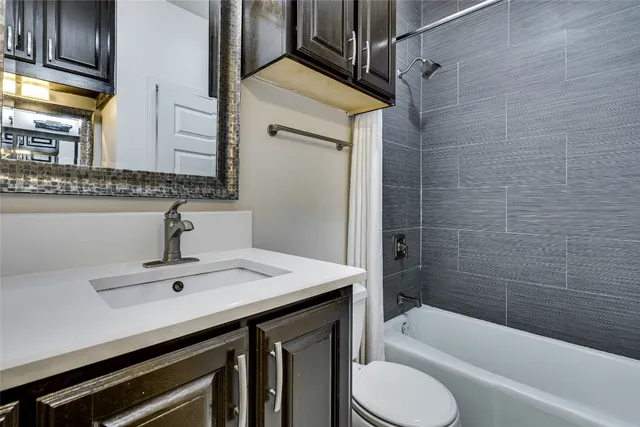 a bathroom with a sink a toilet and bathtub