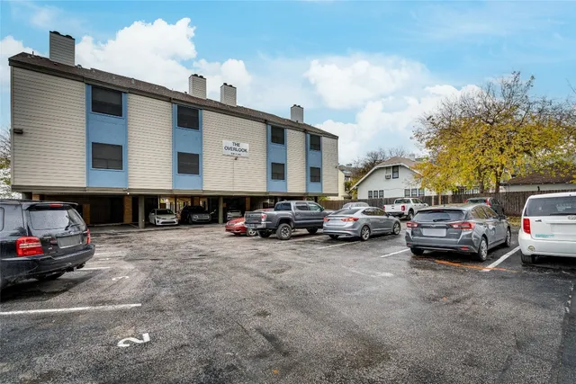a view of cars parked in front of a house