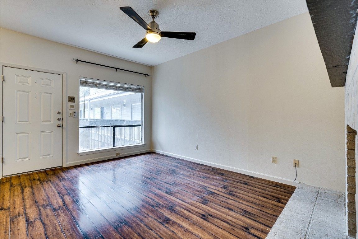 908 Poplar Street, Unit 208 Austin, TX 78705 - Photo 6 of 26 wooden floor in an empty room with a window