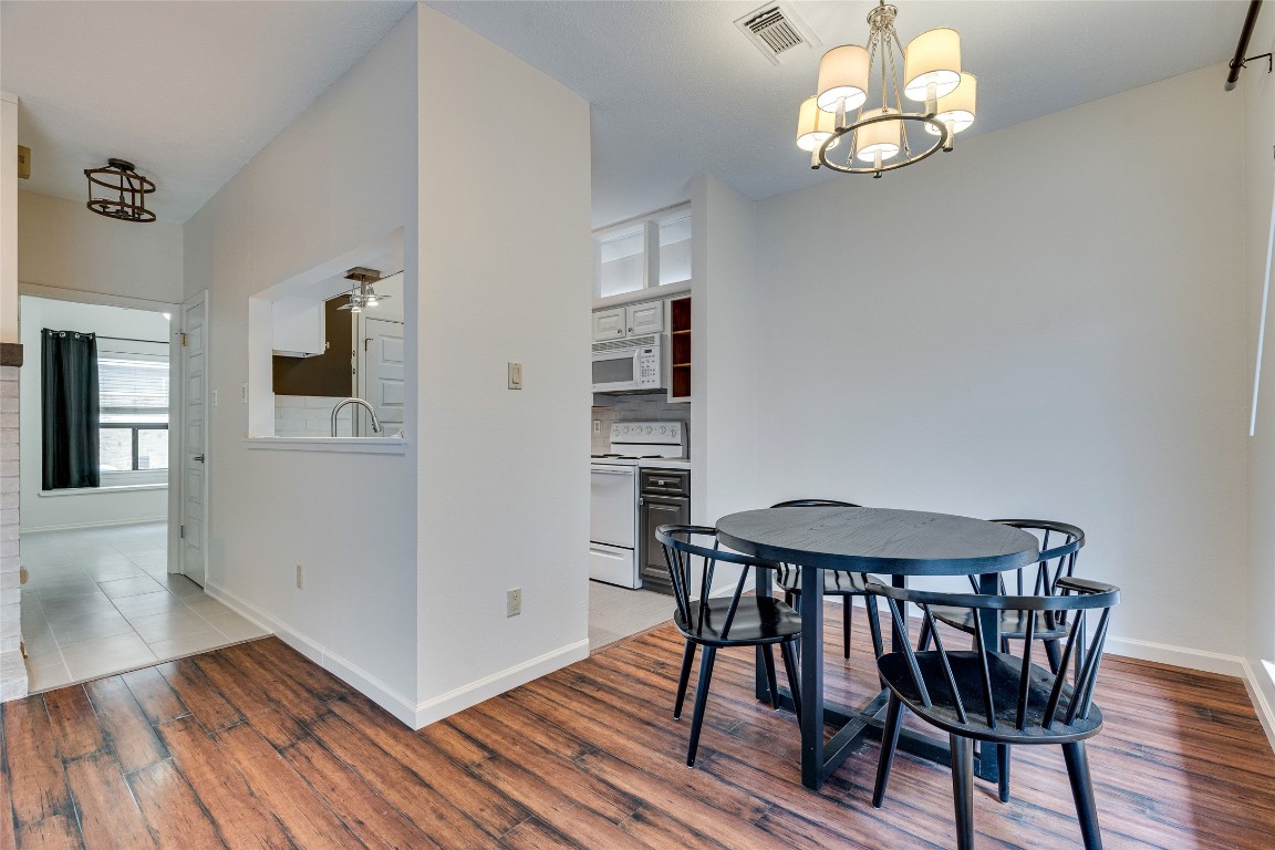 908 Poplar Street, Unit 208 Austin, TX 78705 - Photo 8 of 26 a view of a dining room with furniture and wooden floor