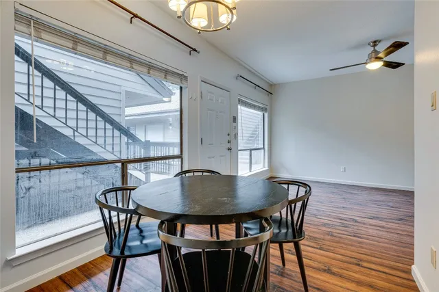 a view of a dining room with furniture and wooden floor