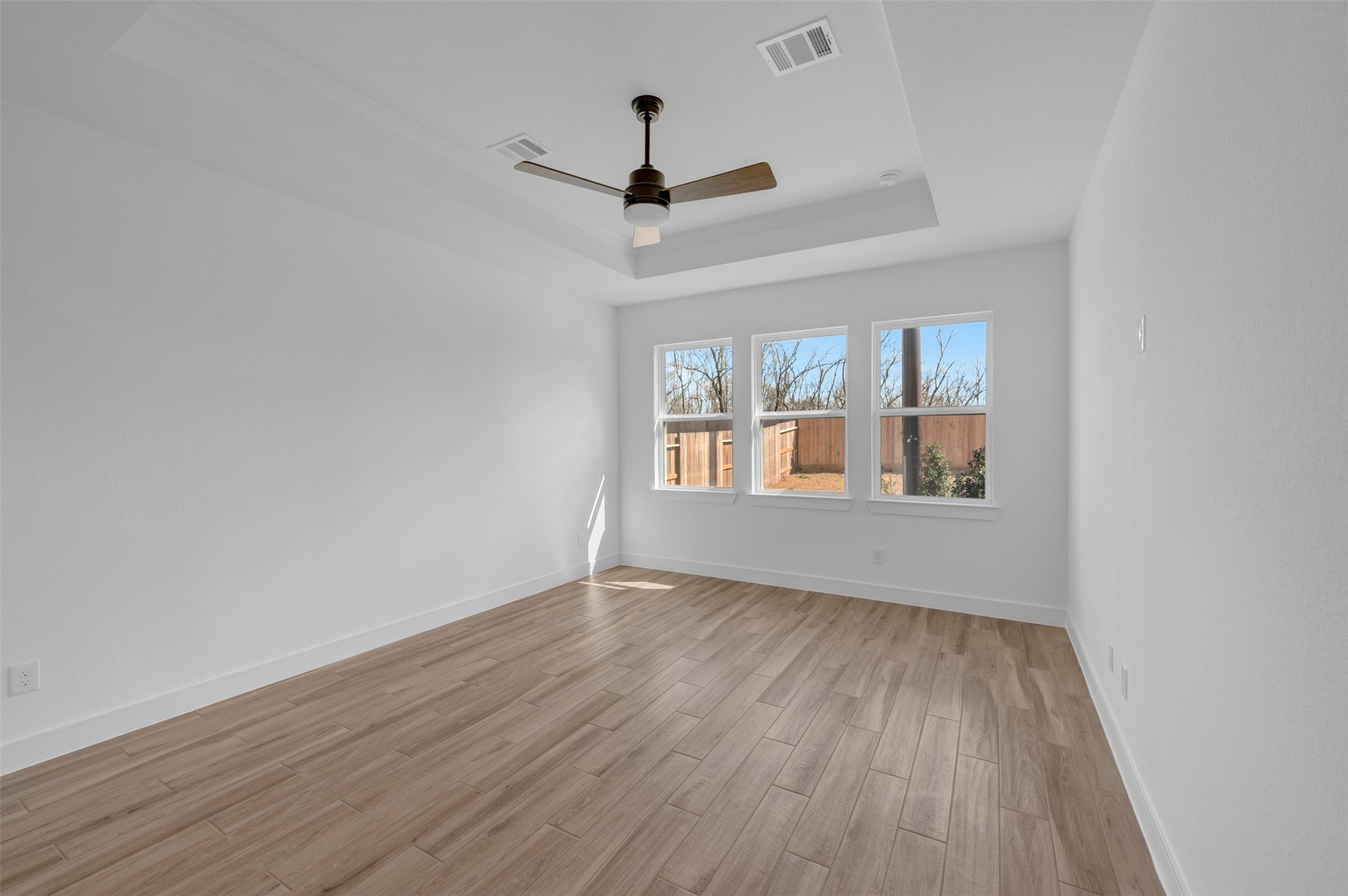 2819 Duchess Drive Rosenberg, TX 77471 - Photo 13 of 37 a view of an empty room with wooden floor ceiling fan and window