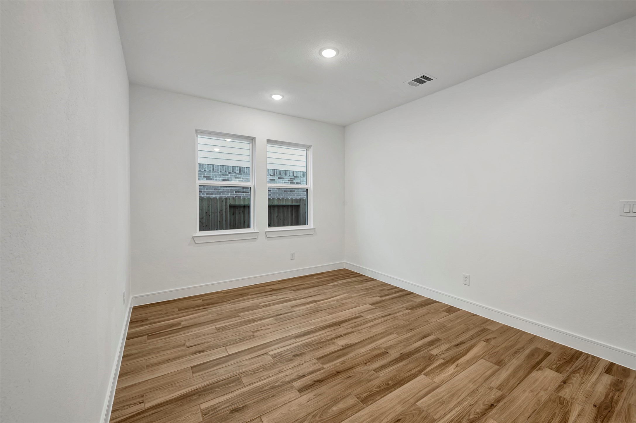 2819 Duchess Drive Rosenberg, TX 77471 - Photo 7 of 37 a view of an empty room with wooden floor and a window