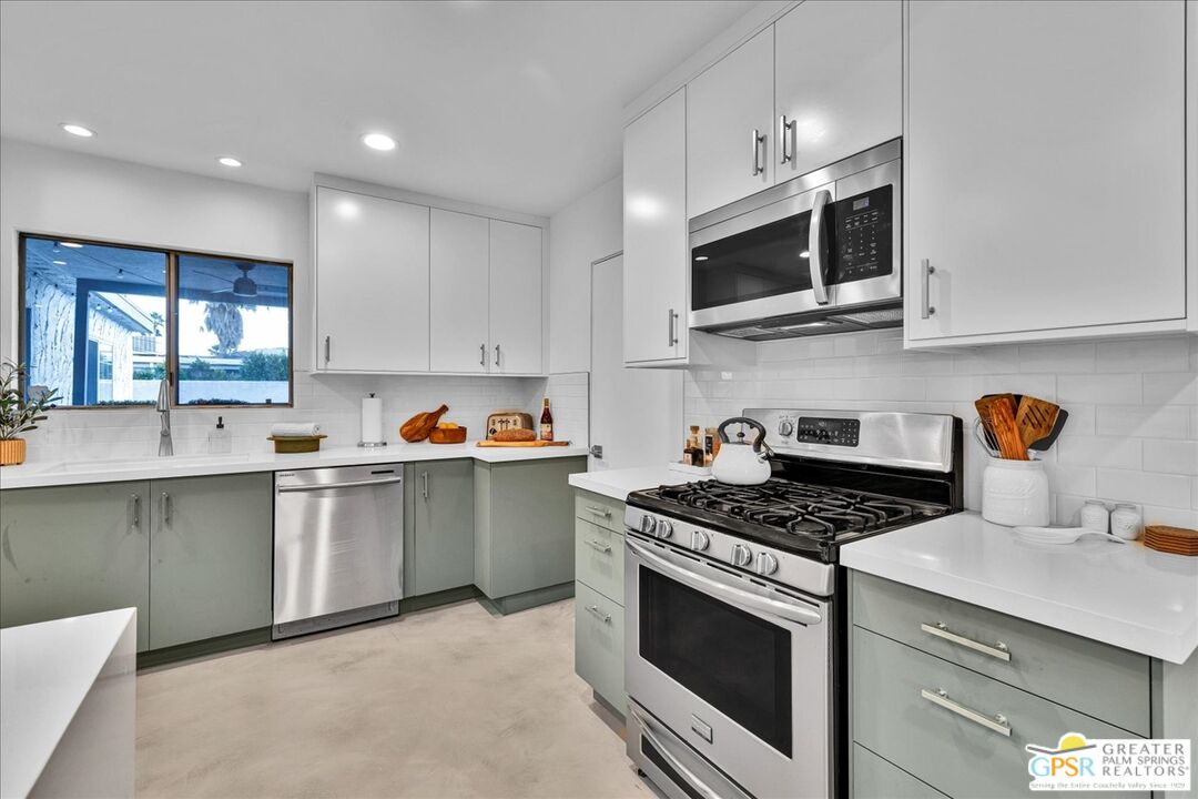 2210 East Powell Road Palm Springs, CA 92262 - Photo 12 of 71 a kitchen with stainless steel appliances granite countertop a sink and a stove