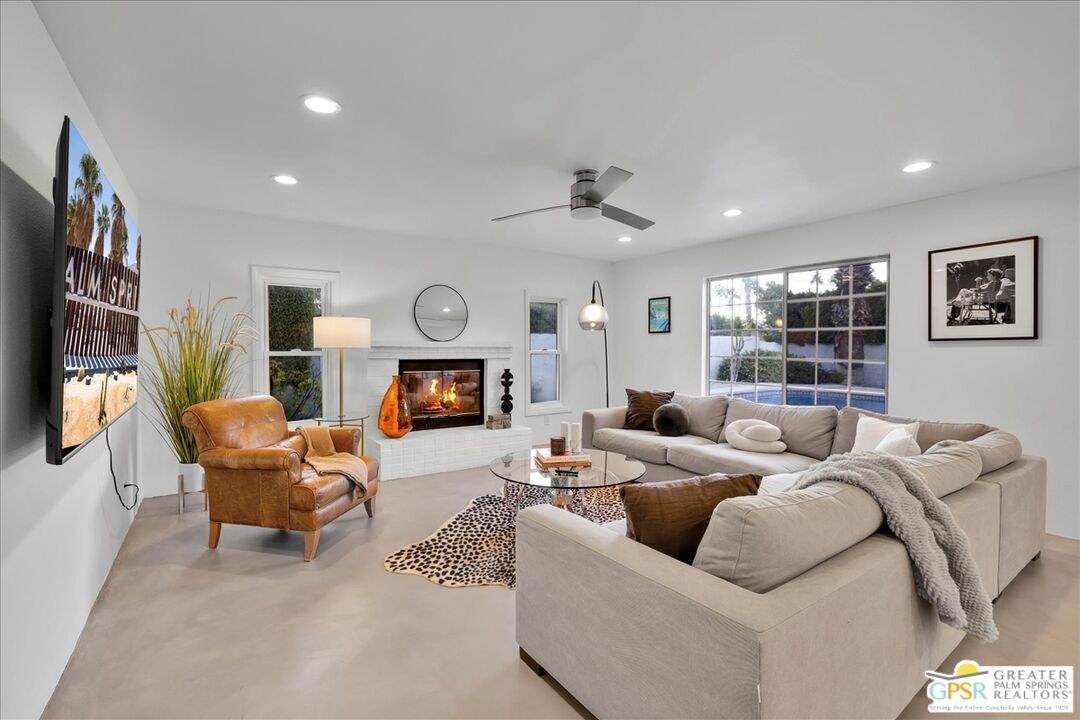 2210 East Powell Road Palm Springs, CA 92262 - Photo 18 of 71 a living room with furniture a fireplace and a flat screen tv