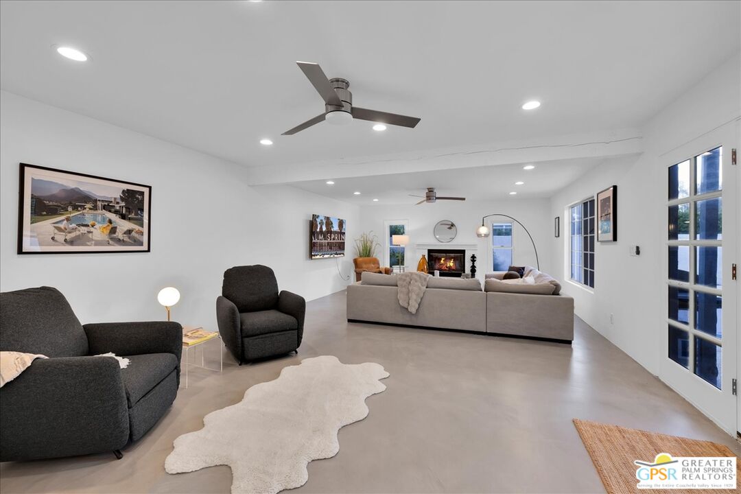 2210 East Powell Road Palm Springs, CA 92262 - Photo 20 of 71 a living room with furniture and a book shelf