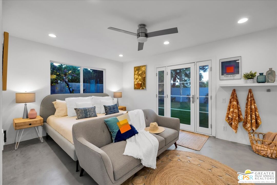 2210 East Powell Road Palm Springs, CA 92262 - Photo 22 of 71 a living room with furniture ceiling fan and a floor to ceiling window