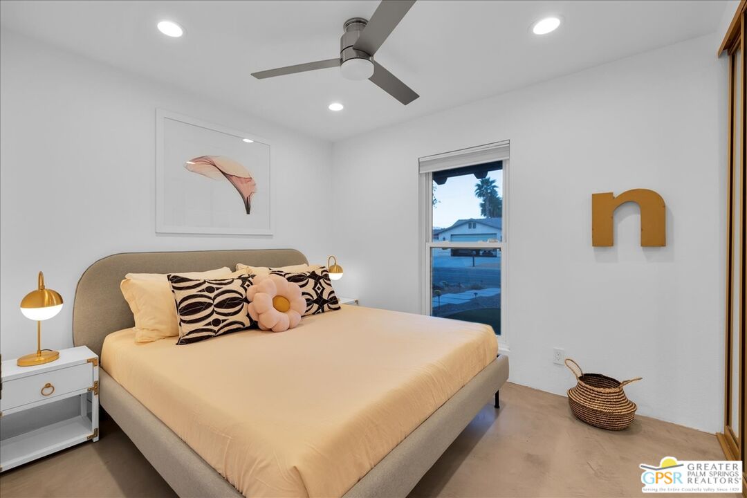 2210 East Powell Road Palm Springs, CA 92262 - Photo 26 of 71 a bedroom with a bed and a painting on the wall