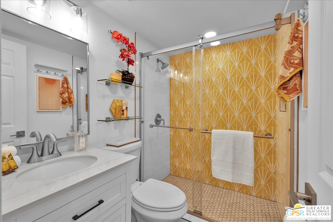 2210 East Powell Road Palm Springs, CA 92262 - Photo 34 of 71 a bathroom with a sink a toilet and shower curtain