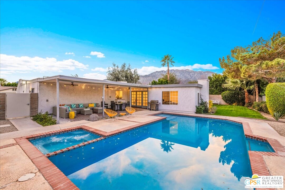 2210 East Powell Road Palm Springs, CA 92262 - Photo 41 of 71 a view of a swimming pool with lounge chairs
