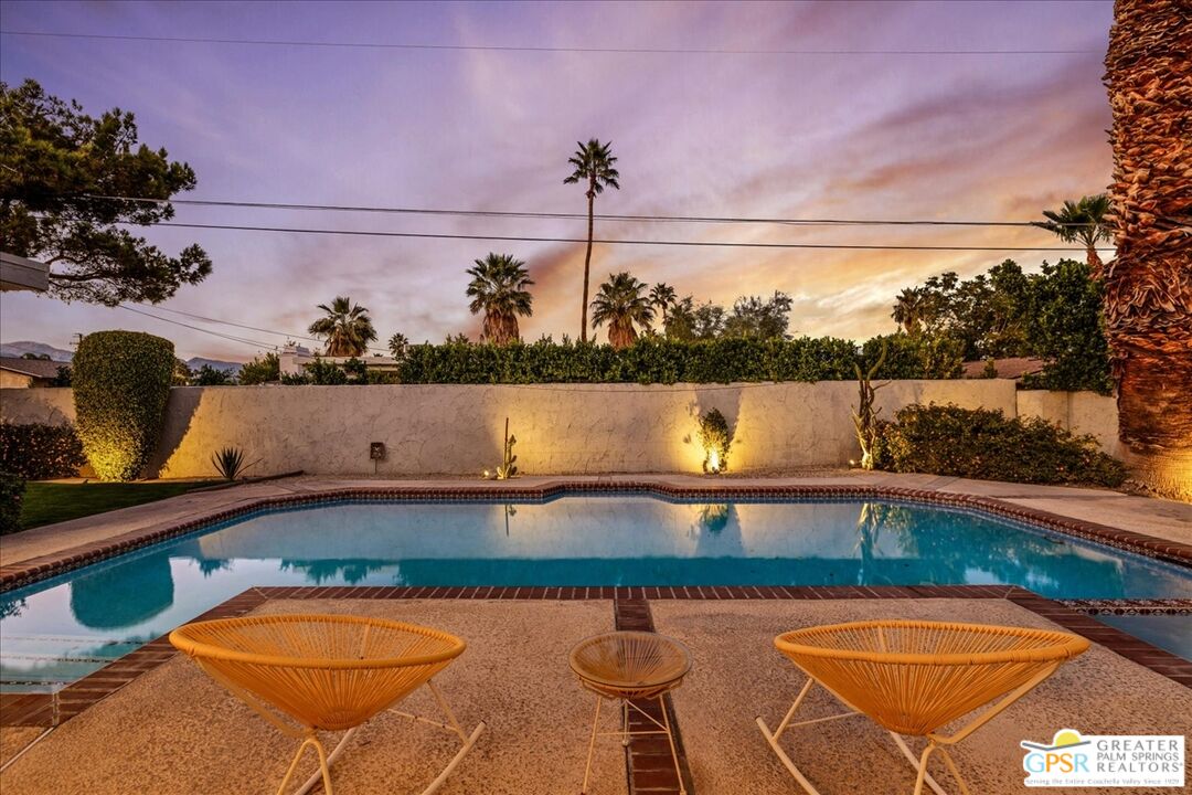 2210 East Powell Road Palm Springs, CA 92262 - Photo 45 of 71 a view of a swimming pool with a lake and mountain view