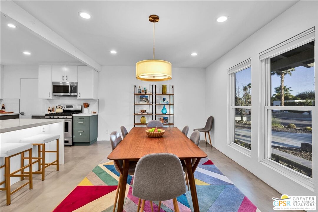 2210 East Powell Road Palm Springs, CA 92262 - Photo 6 of 71 a view of a dining room with furniture and wooden floor