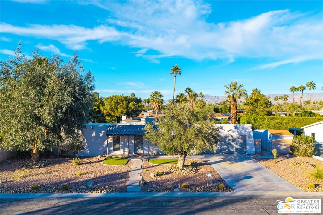 2210 East Powell Road Palm Springs, CA 92262 - Photo 67 of 71 a view of a swimming pool with an outdoor space and seating area