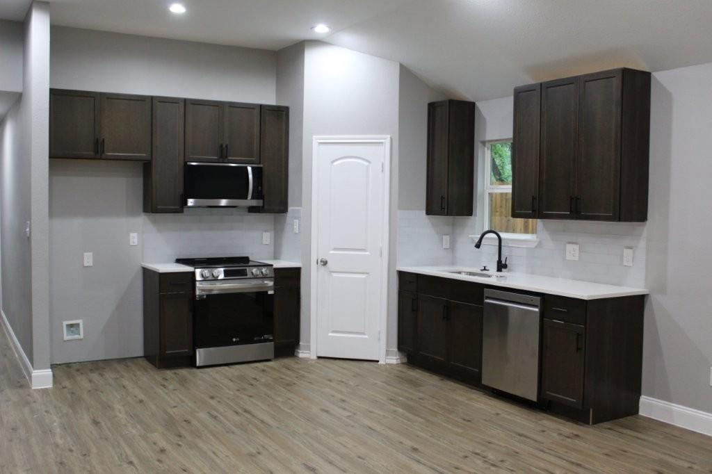 125 Chapperall Drive Mabank, TX 75156 - Photo 7 of 11 a kitchen with stainless steel appliances wooden cabinets and granite counter tops