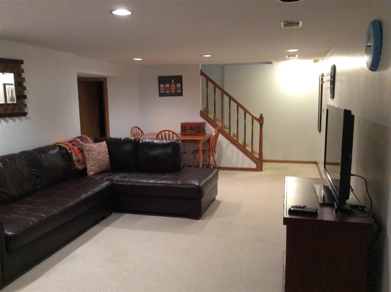 7169 Sentinel Road Rockford, IL 61107 - Photo 20 of 25 a living room with furniture and a flat screen tv