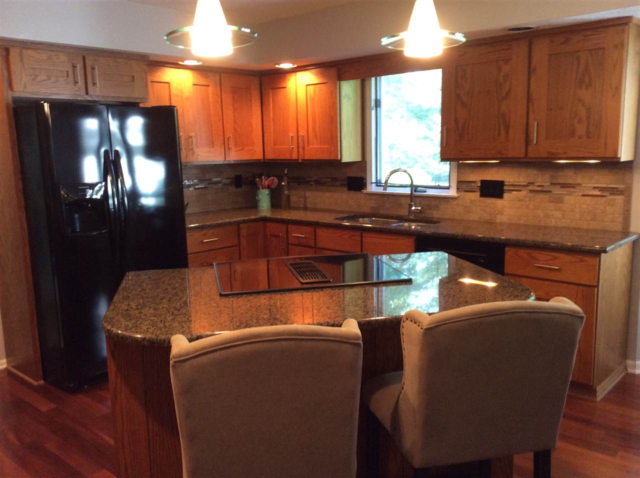 7169 Sentinel Road Rockford, IL 61107 - Photo 5 of 25 a kitchen with stainless steel appliances kitchen island granite countertop a refrigerator a stove and a sink with wooden floor