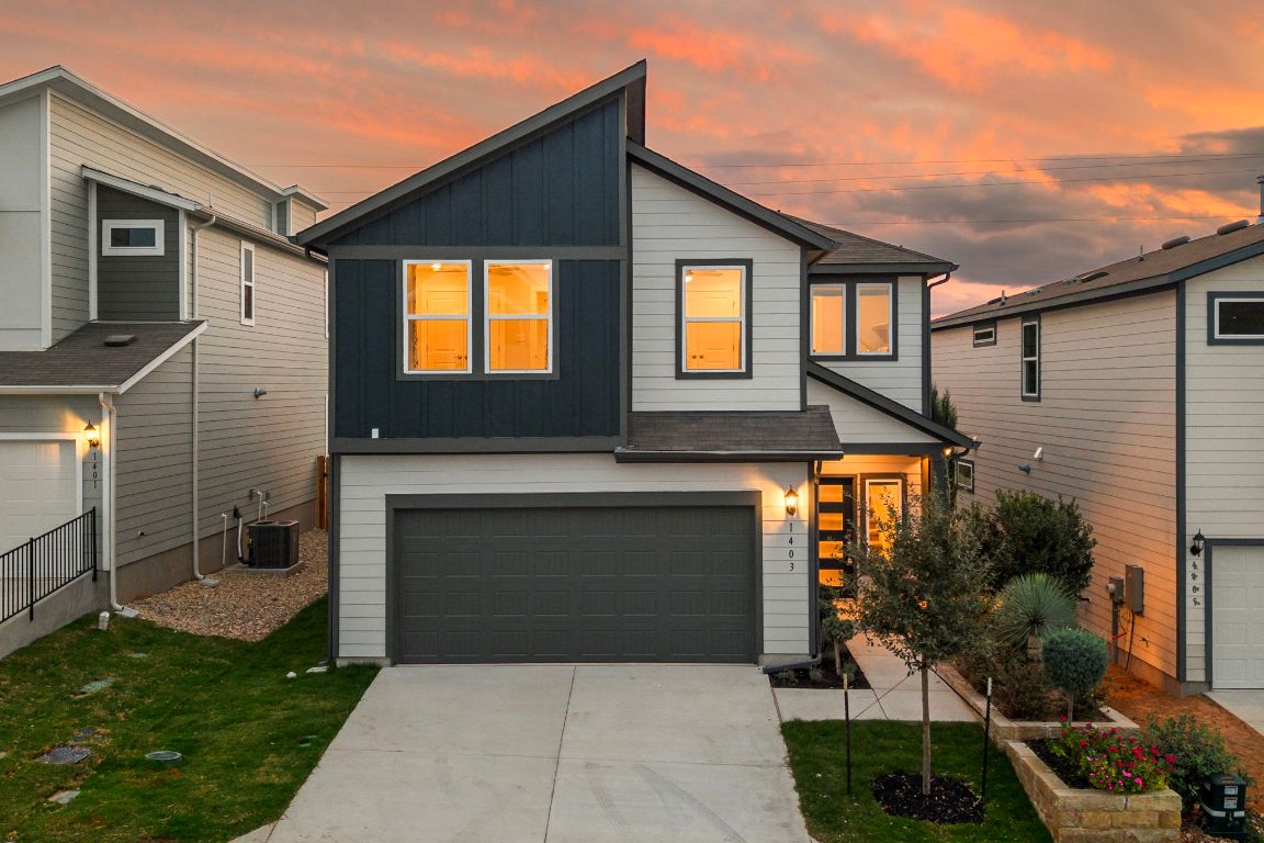 1403 Iberville Drive Pflugerville, TX 78660 - Photo 1 of 40 a front view of a house with garden