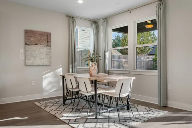 a dining room with furniture and window