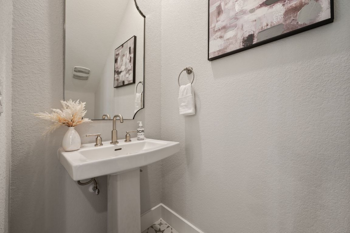 1403 Iberville Drive Pflugerville, TX 78660 - Photo 19 of 40 a bathroom with a sink and a mirror