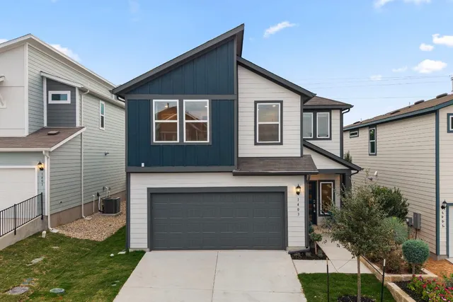 a front view of a house with a garden and plants