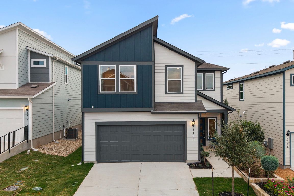 1403 Iberville Drive Pflugerville, TX 78660 - Photo 2 of 40 a front view of a house with a garden and plants