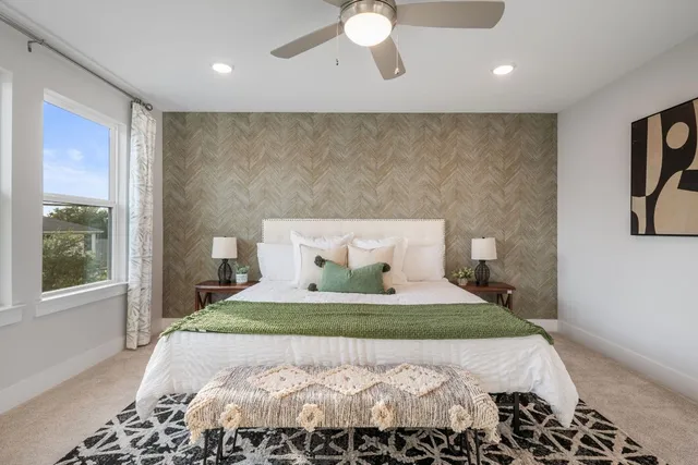 a bedroom with a large bed and a large mirror