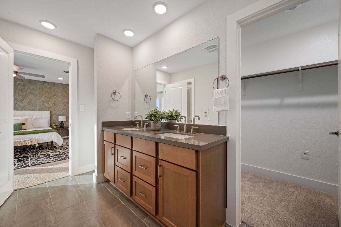 1403 Iberville Drive Pflugerville, TX 78660 - Photo 28 of 40 a bathroom with a shower sink and mirror