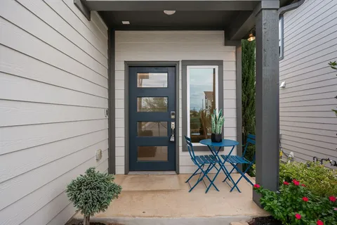 a bench and table in front of a house