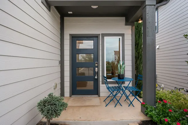 a bench and table in front of a house