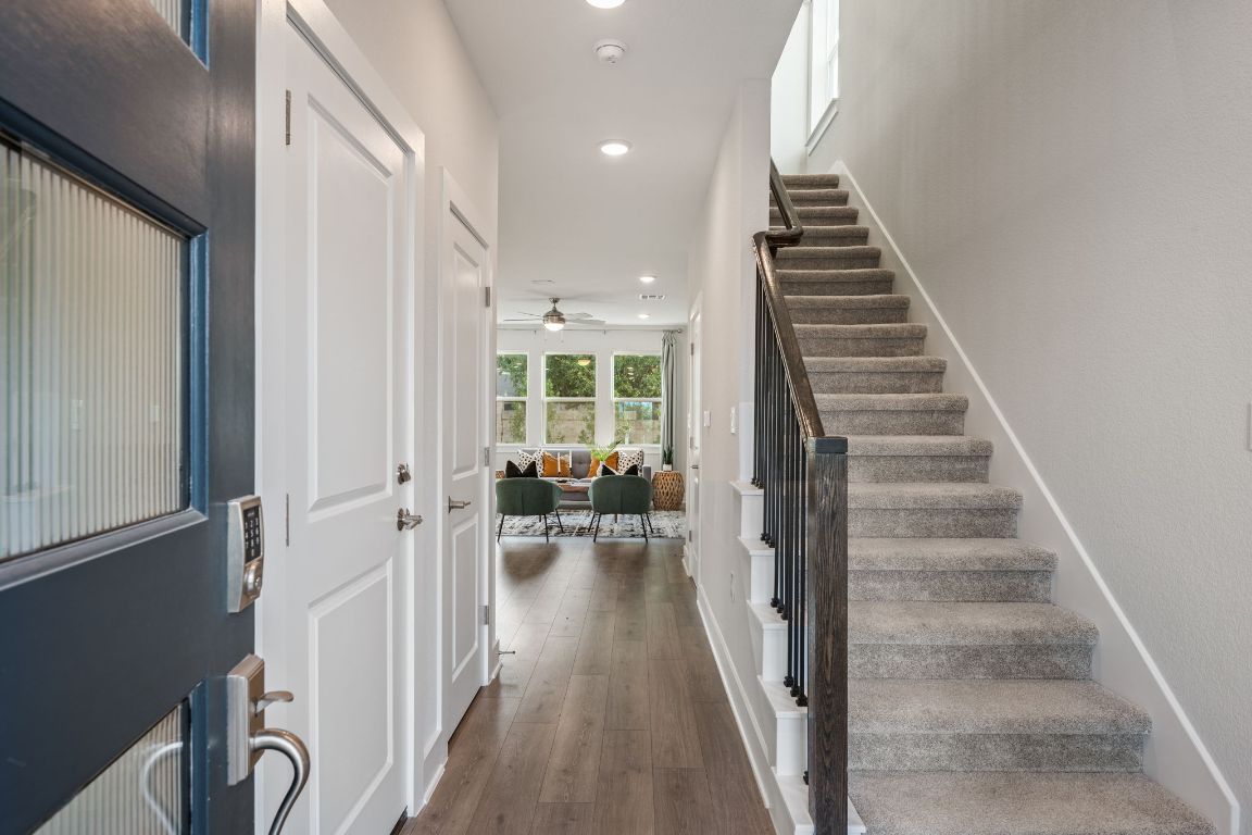1403 Iberville Drive Pflugerville, TX 78660 - Photo 4 of 40 a view of hallway with wooden floor and stairs