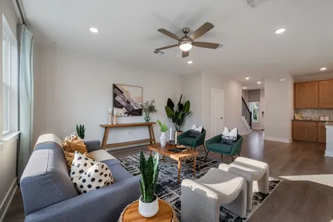a living room with furniture and a chandelier