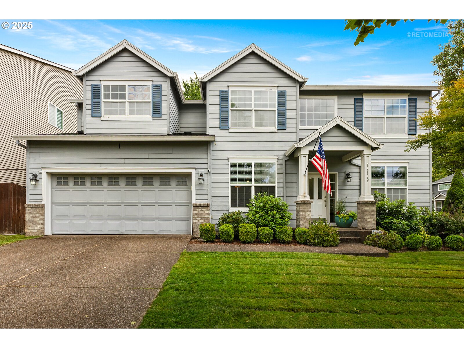 a front view of a house with a yard and garage